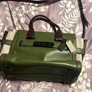 Coach, mid-size purse.  Colors include green, tan and brown.  Only used twice.
